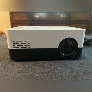 Mini Projector with remote and wall plug in.